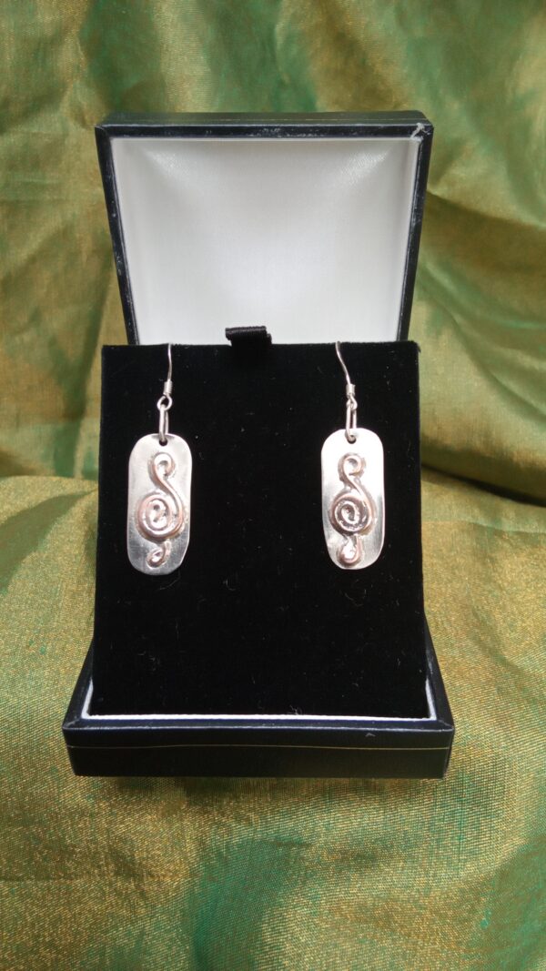 Hand crafted sterling silver earings with copper treble clef inlay made using recycled materials